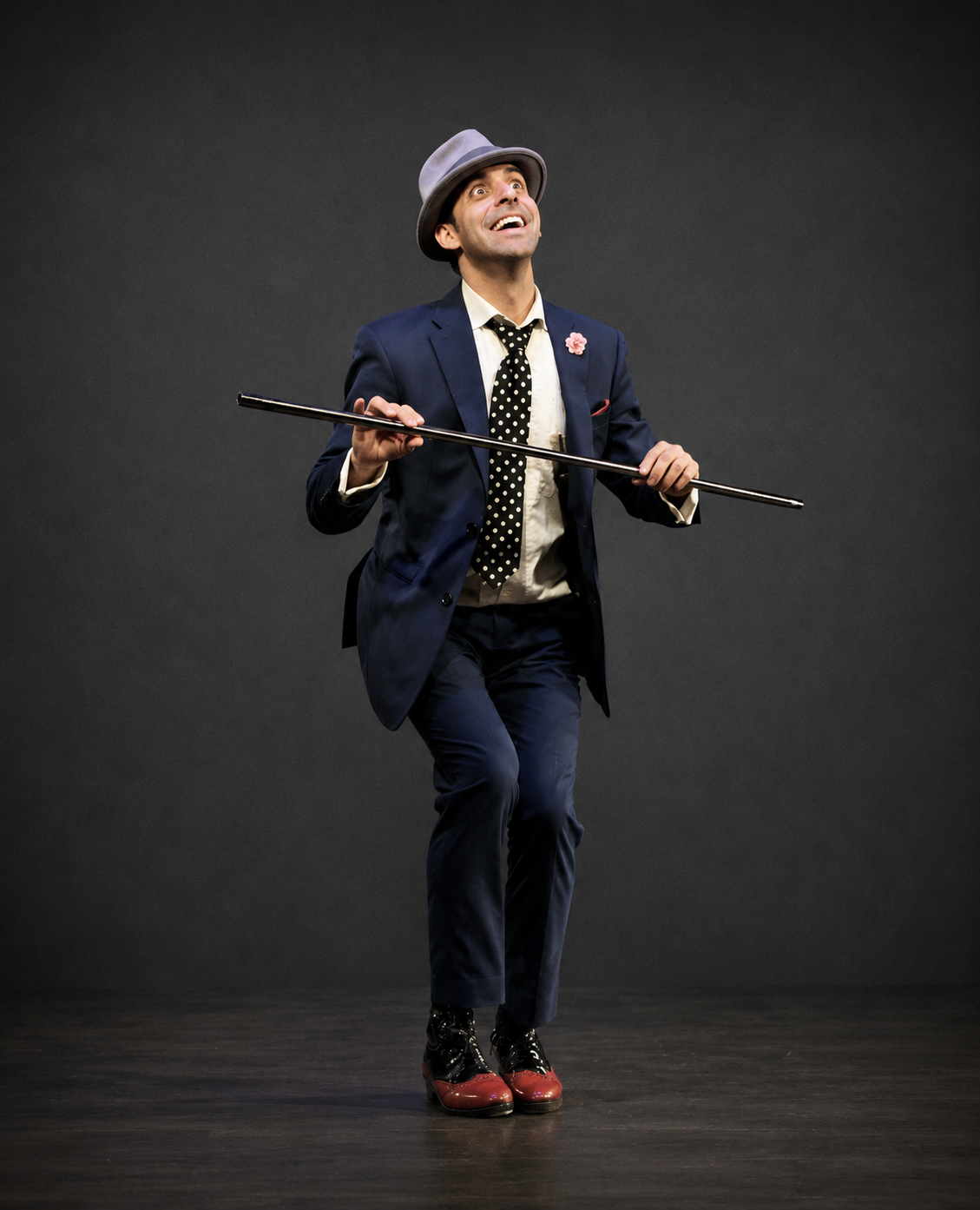 Naz Magic performing on stage in a suit