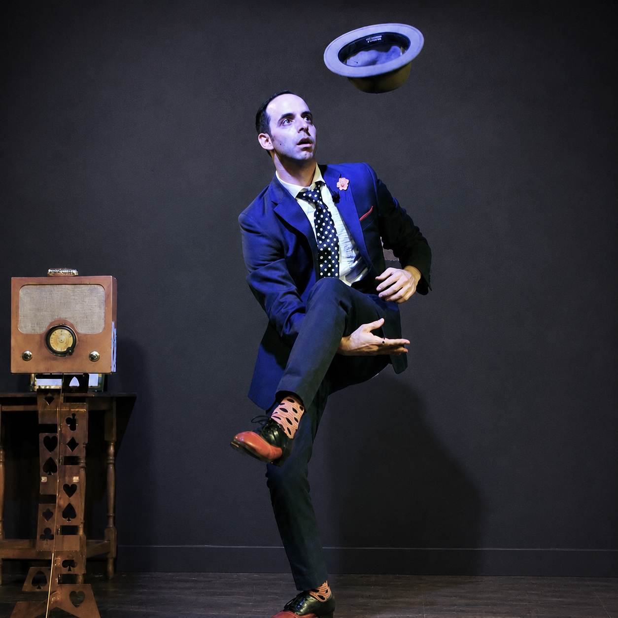 Naz Magic performing on stage in a suit